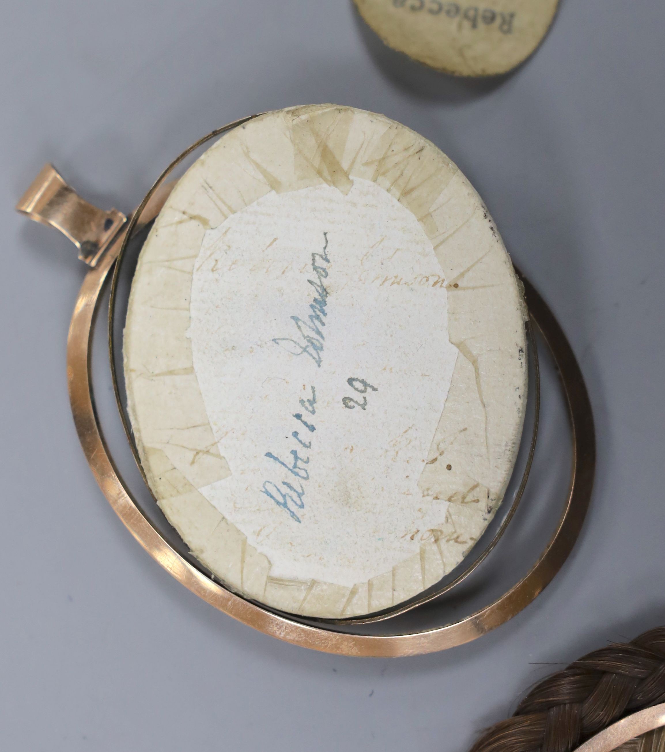 A George III portrait miniature of Rebecca Johnson, inset plaited hair verso, 6cm high